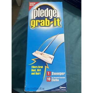 May include: A blue box of Pledge Grab-It cleaning supplies. The box features the product name in yellow and white, along with a graphic of a sweeper. Text on the box indicates it includes 1 sweeper and 10 cloths. The box measures 9 x 11.5 inches.