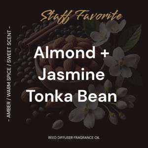 May include: A reed diffuser fragrance oil with a black background and a bowl of almonds, jasmine flowers, and cinnamon sticks. The text "Staff Favorite" is at the top of the image. The text "Almond + Jasmine Tonka Bean" is in the center of the image. The text "REED DIFFUSER FRAGRANCE OIL" is at the bottom of the image.