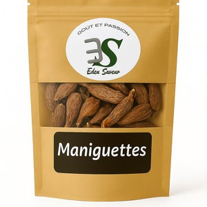 Peut inclure: Un sac en papier brun avec une fenêtre transparente montrant une collection de graines de maniguette brunes. Le sac porte un logo circulaire blanc avec du texte vert et noir qui se lit "Gout et Passion" et "Eden Saveur". Le mot "Maniguettes" est imprimé en blanc sur un rectangle noir.