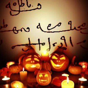 May include: A group of carved pumpkins with lit candles in front of them. The pumpkins are decorated with spooky faces. The text "goblins and ghosts" is written on the wall behind the pumpkins.