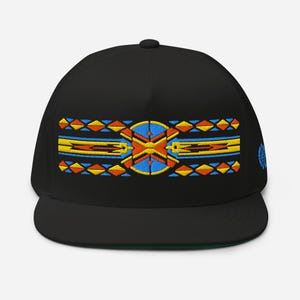 May include: Black flat-brimmed cap with an embroidered geometric design in yellow, orange, and blue. The design features diamond shapes and a central circular element. The cap has a green underside and a small emblem on the side.