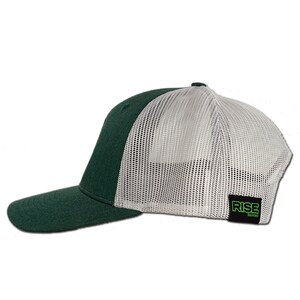 May include: A green and white trucker hat with a mesh back. The hat has a black label on the back that says "RISE DESIGNS".