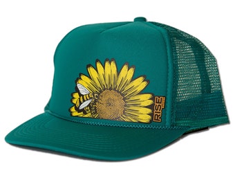 May include: A teal green trucker hat with a yellow sunflower and a bee graphic. The hat has a black mesh back and a brown "RISE" logo on the side.
