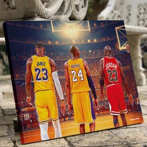 May include: A canvas print featuring three basketball players in their jerseys. LeBron James in a yellow jersey with the number 23, Kobe Bryant in a yellow jersey with the number 24, and Michael Jordan in a red jersey with the number 23.
