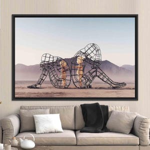 May include: A black and white photograph of three metal sculptures in the shape of people. The sculptures are standing in a desert landscape. The sculptures are made of wire and are very detailed. The sculptures are a mother and two children.
