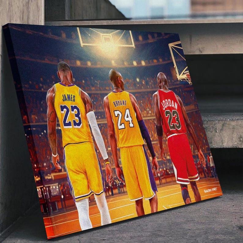 May include: A canvas print featuring three basketball players in action on a court. The players are wearing yellow, purple, and red jerseys with the numbers 23 and 24. The background shows a basketball arena with a hoop and spectators.