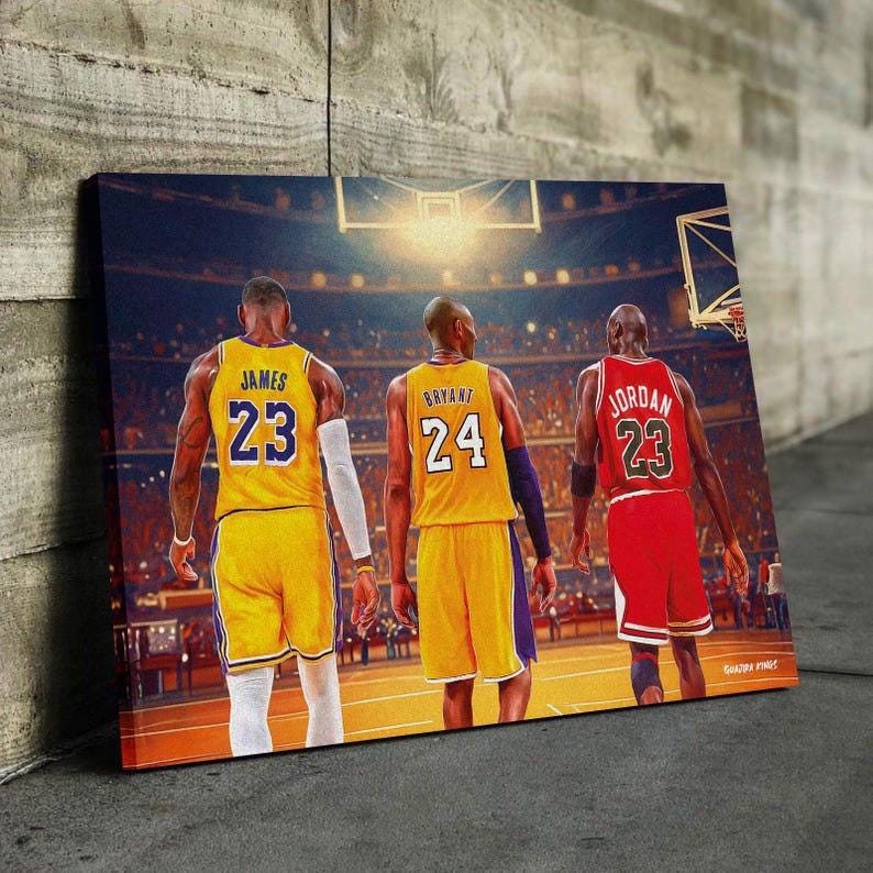 May include: Canvas print featuring three basketball players in their jerseys. LeBron James in a yellow jersey with the number 23, Kobe Bryant in a yellow jersey with the number 24, and Michael Jordan in a red jersey with the number 23.