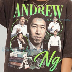 May include: A dark brown t-shirt featuring a large graphic print of Andrew Ng. The design includes multiple portraits of Ng, the text "ANDREW" in lime green, "Ng" in large script, and "COMFORT COLORS ESPRESSO" at the bottom. Books, a floppy disk, and a microphone are also shown.