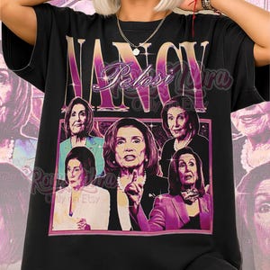 May include: Black unisex t-shirt featuring a graphic of Nancy Pelosi with the text "Nancy Pelosi" in a retro style. The shirt includes multiple images of Pelosi and the words "Unisex Shirt" at the bottom.