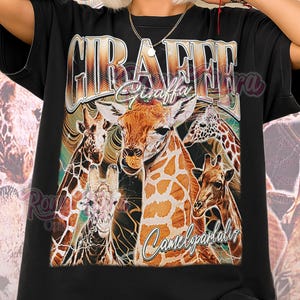 May include: Black unisex shirt featuring a graphic of several giraffes with the words "Giraffe Giraffa Camelopardalis" in a vintage style. The shirt also has the words "Unisex Shirt" at the bottom.