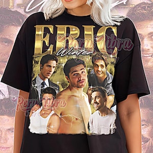 May include: Black unisex t-shirt featuring a gold-colored graphic of the name "ERIC Winter" above a collage of five men. The words "Unisex Shirt" are printed in pink script at the bottom.