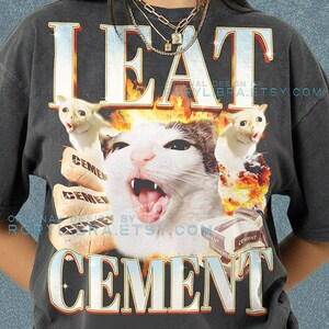 May include: A white ceramic mug with a black handle and the text "But First, Coffee" in a handwritten style. The mug is on a white surface. The mug is approximately 4 inches tall.