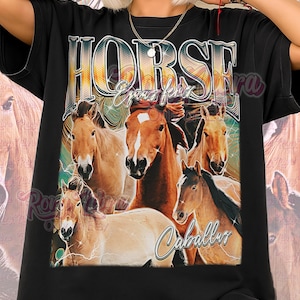 May include: Black unisex shirt featuring a graphic of several horses in shades of brown and tan. The word "HORSE" is displayed in a stylized font above the horses, with the words "Equus ferus" and "Caballus" below.
