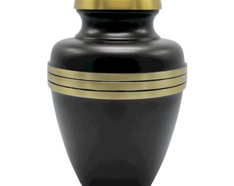 May include: A black urn with gold trim. The urn has a rounded top and a wide base. It is made of metal and has a smooth finish.