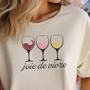 Bella Canvas 3001 wine shirt featuring three wine glasses filled with red, rosé, and white wine with the French phrase "joie de vivre," a perfect French-inspired graphic tee for wine lovers.