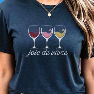 Bella Canvas 3001 wine shirt featuring three wine glasses filled with red, rosé, and white wine with the French phrase "joie de vivre," a perfect French-inspired graphic tee for wine lovers.