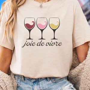 Bella Canvas 3001 wine shirt featuring three wine glasses filled with red, rosé, and white wine with the French phrase "joie de vivre," a perfect French-inspired graphic tee for wine lovers.