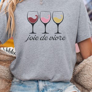 Bella Canvas 3001 wine shirt featuring three wine glasses filled with red, rosé, and white wine with the French phrase "joie de vivre," a perfect French-inspired graphic tee for wine lovers.