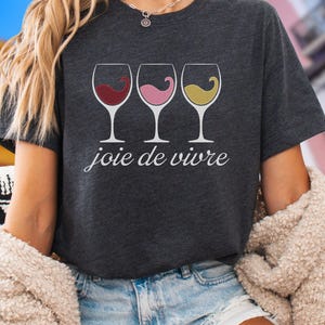 Bella Canvas 3001 wine shirt featuring three wine glasses filled with red, rosé, and white wine with the French phrase "joie de vivre," a perfect French-inspired graphic tee for wine lovers.