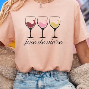 Bella Canvas 3001 wine shirt featuring three wine glasses filled with red, rosé, and white wine with the French phrase "joie de vivre," a perfect French-inspired graphic tee for wine lovers.