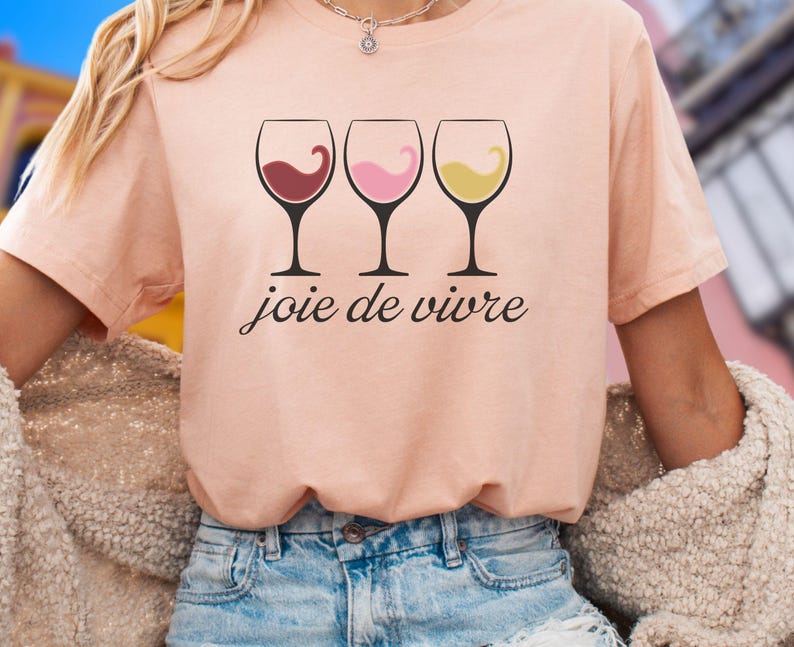 Bella Canvas 3001 wine shirt featuring three wine glasses filled with red, rosé, and white wine with the French phrase "joie de vivre," a perfect French-inspired graphic tee for wine lovers.