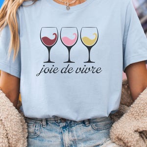 Bella Canvas 3001 wine shirt featuring three wine glasses filled with red, rosé, and white wine with the French phrase "joie de vivre," a perfect French-inspired graphic tee for wine lovers.