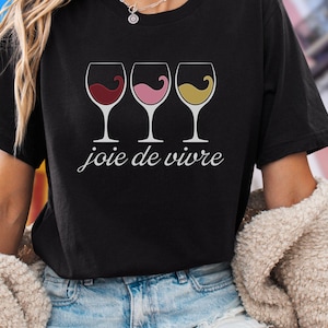 Bella Canvas 3001 wine shirt featuring three wine glasses filled with red, rosé, and white wine with the French phrase "joie de vivre," a perfect French-inspired graphic tee for wine lovers.