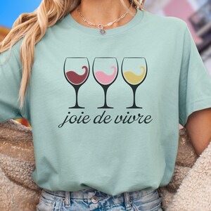 Bella Canvas 3001 wine shirt featuring three wine glasses filled with red, rosé, and white wine with the French phrase "joie de vivre," a perfect French-inspired graphic tee for wine lovers.