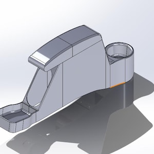 May include: A gray 3D model of a car part with a cup holder and a small tray. The part is designed to be mounted on a car's dashboard.