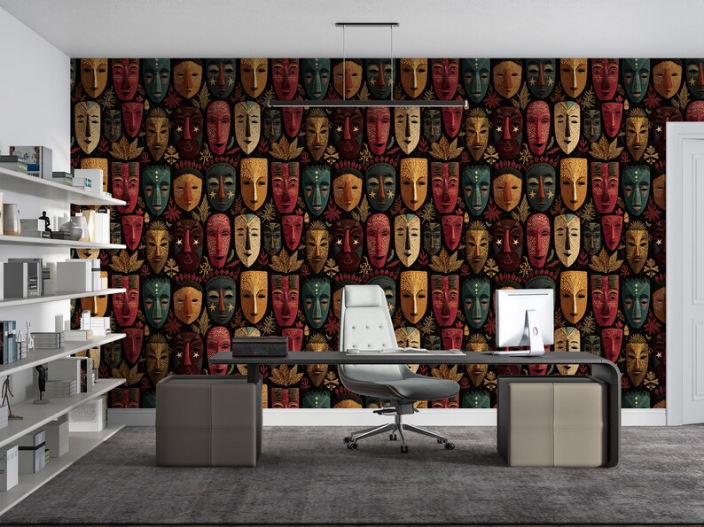 May include: A home office with a dark patterned wallpaper featuring repeating tribal masks in red, green, gold, and brown. The room includes a desk, chair, and shelving unit, creating a workspace with a cultural theme.