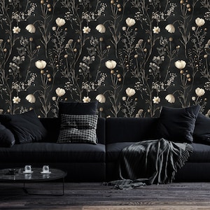 May include: A black couch with black throw pillows and a black and white throw blanket in front of a black and white floral wallpaper.
