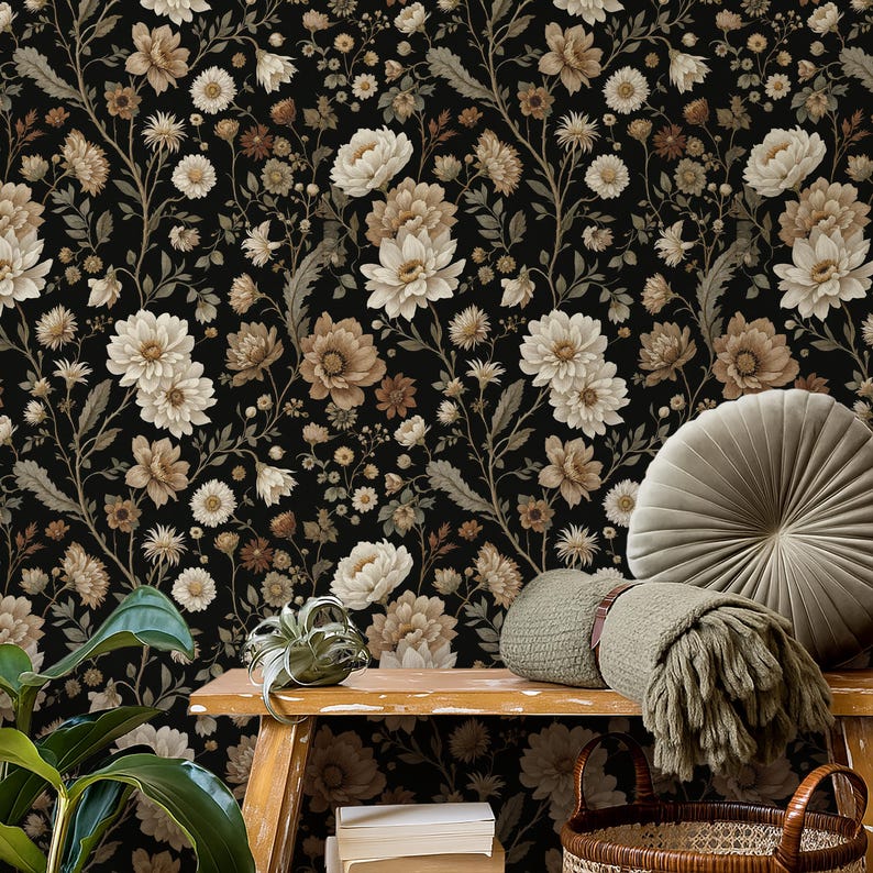 May include: Floral wallpaper featuring a repeating pattern of beige, cream, and brown flowers and foliage against a black background. The image includes a wooden bench with decorative pillows, a blanket, and a woven basket.