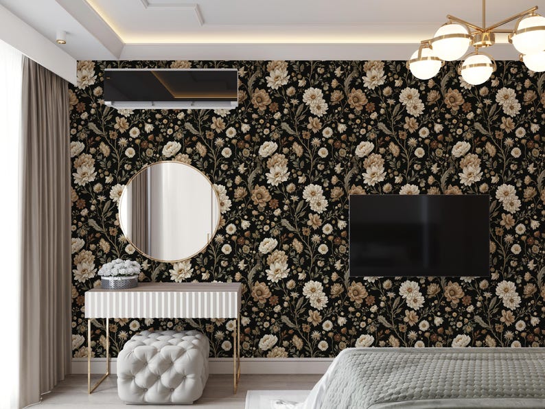May include: A bedroom with floral wallpaper in black, beige, and cream tones. The room features a vanity with a round mirror, a tufted ottoman, and a flat-screen TV. A modern chandelier hangs from the ceiling.