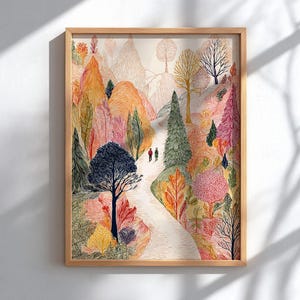 May include: A framed art print featuring a colorful landscape with a winding path. The artwork showcases a variety of trees in shades of orange, pink, and green, with two small figures walking along the path. The frame is made of light-colored wood.