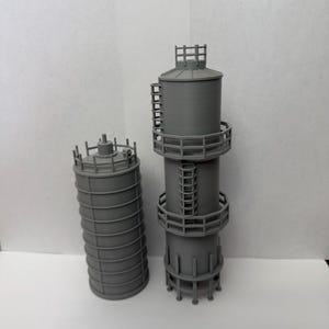 May include: A set of three ceramic mugs with a speckled, matte finish. The mugs are in shades of cream, light gray, and dark gray. Each mug has a simple, minimalist design, perfect for coffee or tea.