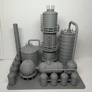 May include: A gray 3D-printed model of an industrial complex, featuring multiple cylindrical tanks, a tall smokestack, and connecting pipes. The model includes ladders and various rounded structures, all on a rectangular base.