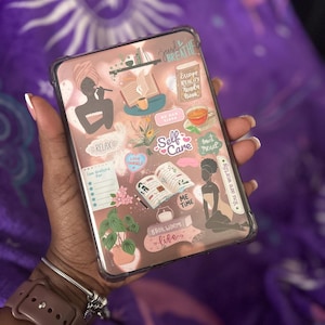 May include: A clear phone case with a rose gold interior, decorated with self-care themed stickers. The stickers include text like "Self Care", "Relax", and "Escape Reality". Other stickers depict books, tea, and a woman in a towel.