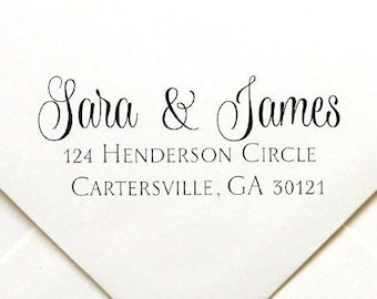May include: A white envelope with a black ink return address stamp that reads "Sara & James 124 Henderson Circle Cartersville, GA 30121"