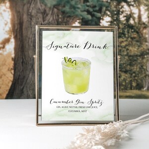 Puede incluir: Un cartel imprimible con una ilustraci&oacute;n de acuarela de un c&oacute;ctel spritz de ginebra y pepino. El cartel dice "Signature Drink" y "Cucumber Gin Spritz" con los ingredientes enumerados a continuaci&oacute;n: "Ginebra, n&eacute;ctar de agave, jugo de lima fresco, pepino, menta."