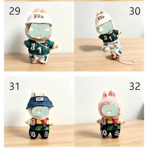 May include: A collection of plush bunny dolls wearing soccer-themed outfits. The dolls are dressed in green and white jerseys with the number 1 or 10, and some wear hats. The text "Suitable for 17cm dolls" is also visible.