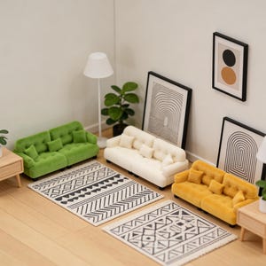 May include: Miniature living room scene with a green, cream, and yellow sofa, two patterned rugs, framed art, and a floor lamp. The scene includes a small side table with a plant and a potted plant.