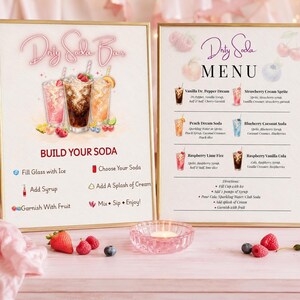 May include: Two framed signs for a Dirty Soda Bar. The left sign features three soda illustrations and instructions: Fill Glass with Ice, Choose Your Soda, Add Syrup, Add A Splash of Cream, Garnish With Fruit, Mix, Sip, Enjoy. The right sign lists a menu.