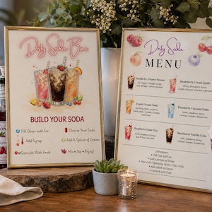 May include: Two framed signs for a Dirty Soda Bar and Menu with gold frames. The signs feature illustrations of soda drinks, fruit, and instructions for building a soda. The menu lists various soda combinations with ingredients and directions.