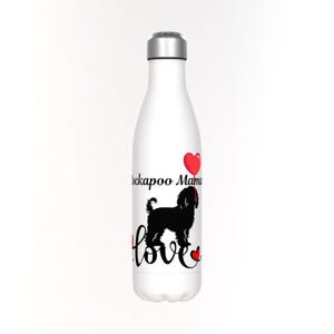 May include: White water bottle with a silver cap. The bottle features a black silhouette of a Cockapoo dog, the words "Cockapoo Mama" and the word "love" in a script font, along with red heart accents.
