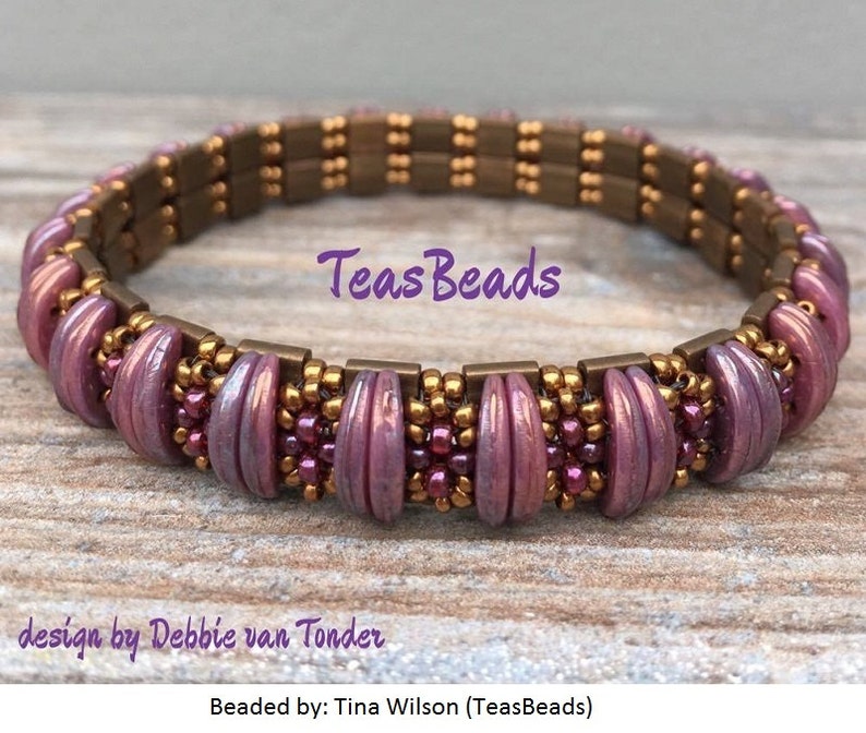 Peut inclure: Un bracelet en perles de couleur violette et dor&eacute;e avec le texte "Teas Beads" et "design by Debbie van Tonder" et "Beaded by: Tina Wilson (TeasBeads)"