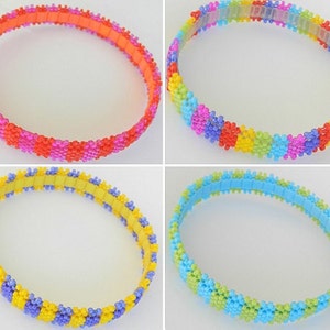 May include: Four colorful beaded bracelets with different color combinations. The bracelets are made of small, round beads in shades of pink, orange, yellow, green, blue, and purple.