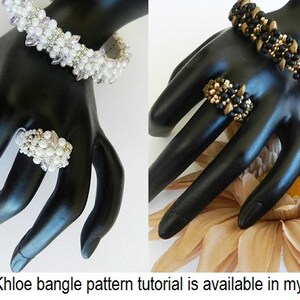May include: Two beaded bracelets and rings. One bracelet is white and silver with a ring of the same colour. The other bracelet is black and gold with a ring of the same colour.