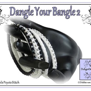 May include: A set of four black and white beaded bracelets in a double peyote stitch. The bracelets are stacked on a black hand-shaped display stand. The text "Dangle Your Bangle 2" is at the top of the image. The text "Double Peyote Stitch" is at the bottom of the image. The text "DebbiegerDesigns" and "©Debbie van Tonder" are at the bottom right of the image.