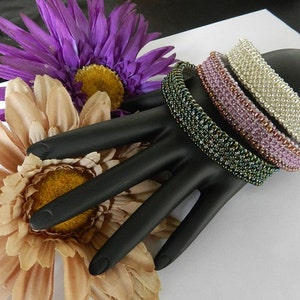 May include: A close-up of a Japanese woodworking chisel with a wooden handle and a sharp blade. The chisel is resting on a wooden surface with wood shavings scattered around it.