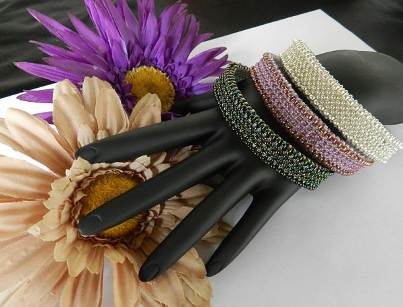 May include: A close-up of a Japanese woodworking chisel with a wooden handle and a sharp blade. The chisel is resting on a wooden surface with wood shavings scattered around it.